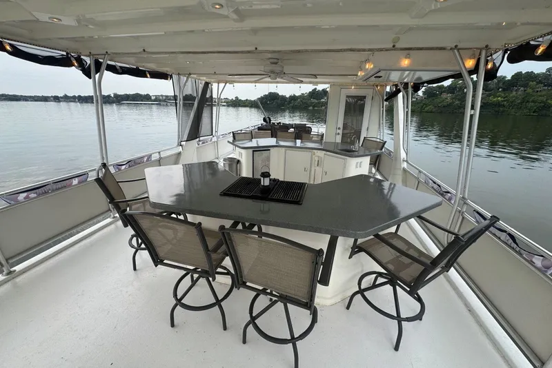 Slide: The Image of Luxurious 2005 Sumerset houseboat with spacious outdoor seating and scenic lake views. - 27