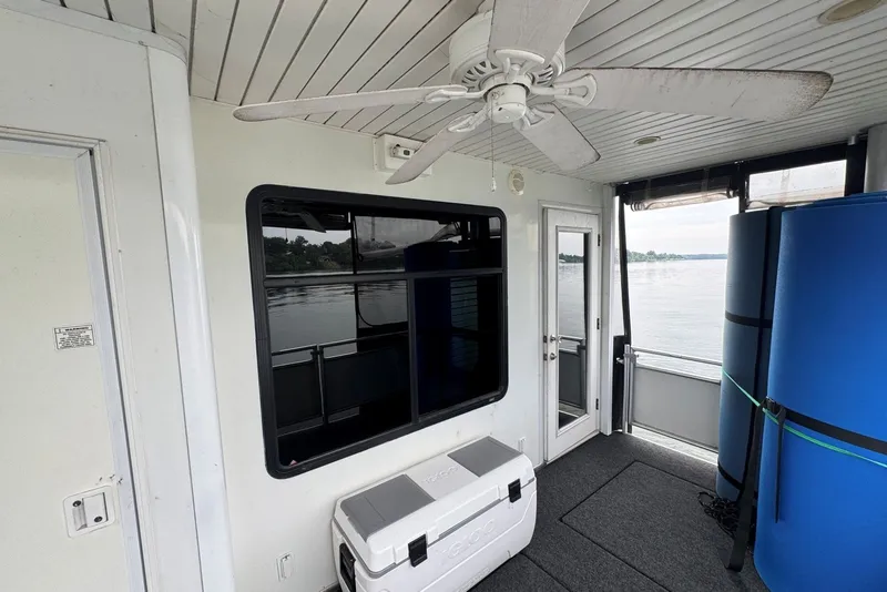 Slide: The Image of 2005 Sumerset houseboat deck with ceiling fan, window, and lake view. - 96