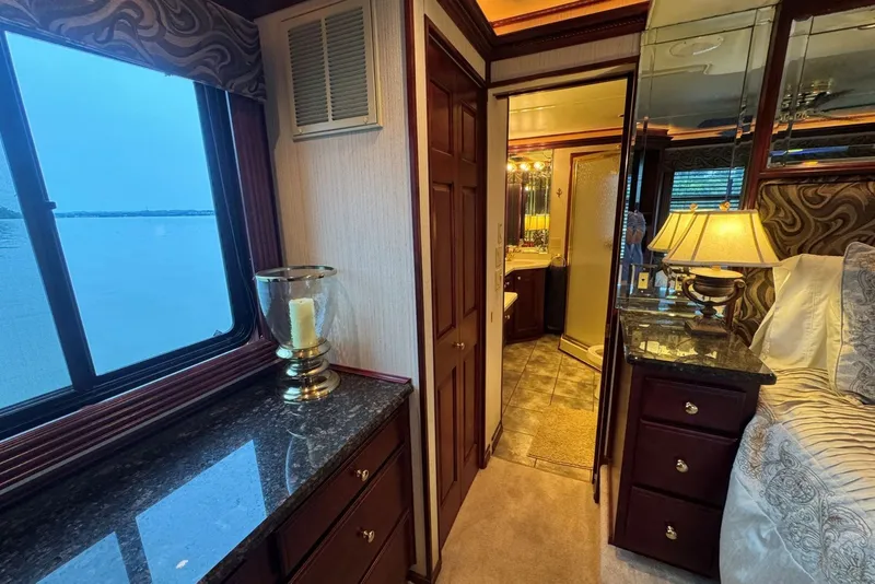 Slide: The Image of Luxurious 2005 Sumerset houseboat interior with elegant bedroom and bathroom view. - 84