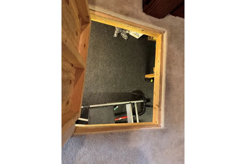 Slide: The Image of Hatch opening in 2005 Sumerset 16'6" X 63 houseboat, revealing interior storage space. - 105