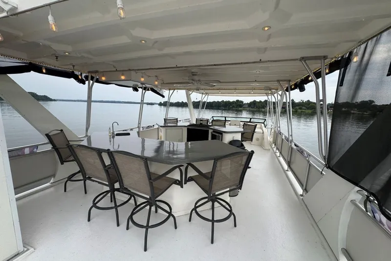 Slide: The Image of Spacious deck of 2005 Sumerset 16'6" X 63 houseboat with seating and scenic lake view. - 37