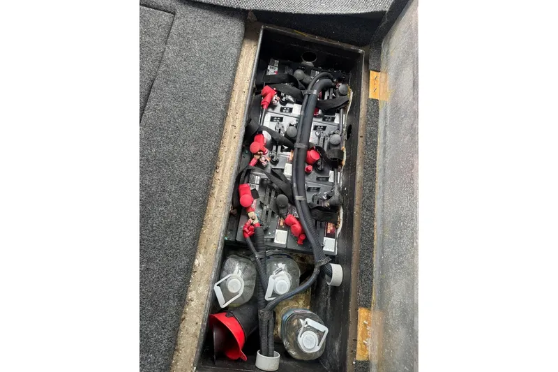 Slide: The Image of Battery compartment of a 2005 Sumerset 16'6" X 63 houseboat, showing wiring and connections. - 108