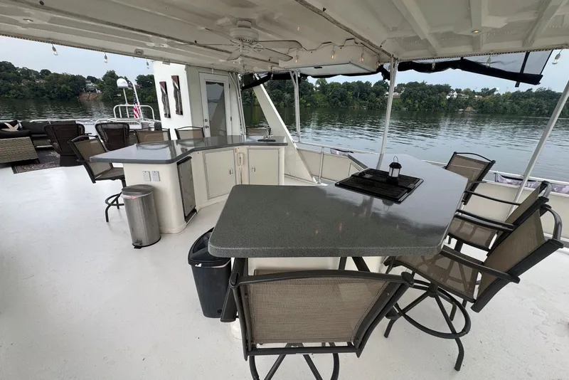 Slide: The Image of Spacious 2005 Sumerset houseboat deck with bar seating and scenic lake view. - 28