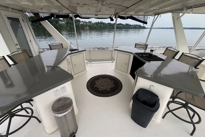 Slide: The Image of Luxurious 2005 Sumerset houseboat interior with modern kitchen and scenic lake view. - 29