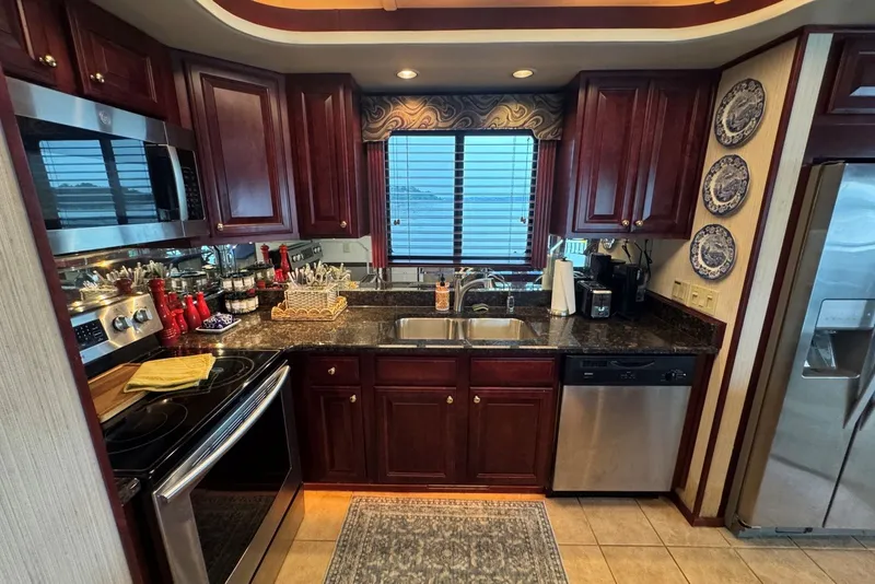 Slide: The Image of Luxurious kitchen in a 2005 Sumerset houseboat with cherry wood cabinets and modern appliances. - 54
