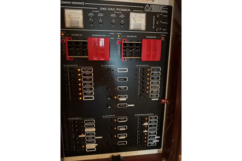 Slide: The Image of Electrical panel of a 2005 Sumerset 16'6" X 63 houseboat, showing 240 VAC power controls. - 102