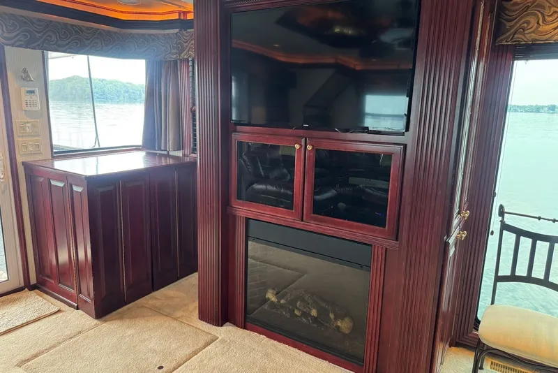Slide: The Image of Luxurious 2005 Sumerset houseboat interior with TV, fireplace, and lake view. - 48