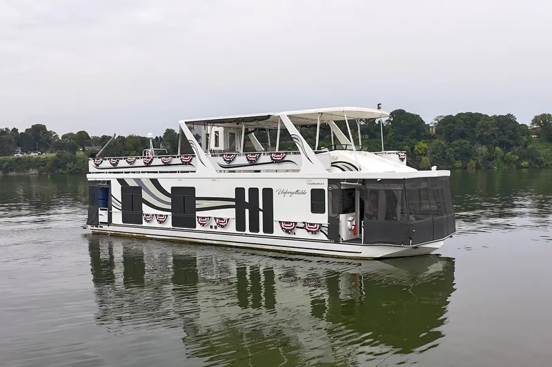Slide: The Image of 2005 Sumerset 16'6" X 63 houseboat on a calm lake with scenic background. - 16