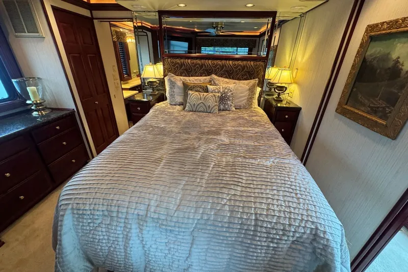 Slide: The Image of Luxurious bedroom interior in a 2005 Sumerset houseboat, featuring elegant bedding and warm lighting. - 82