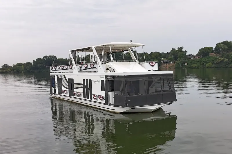 Slide: The Image of 2005 Sumerset 16'6" X 63 houseboat on a calm lake with scenic background. - 18