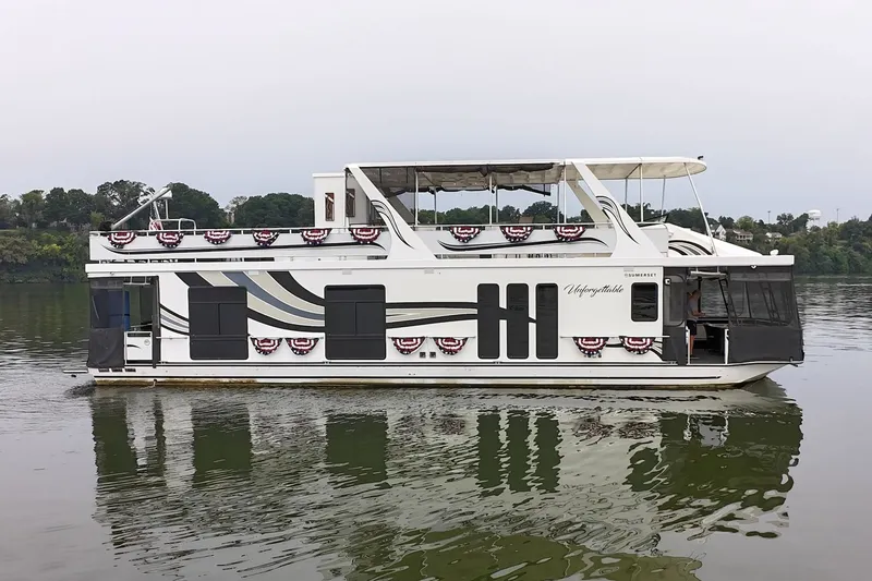 Slide: The Image of 2005 Sumerset houseboat on calm water, decorated with patriotic banners. - 13