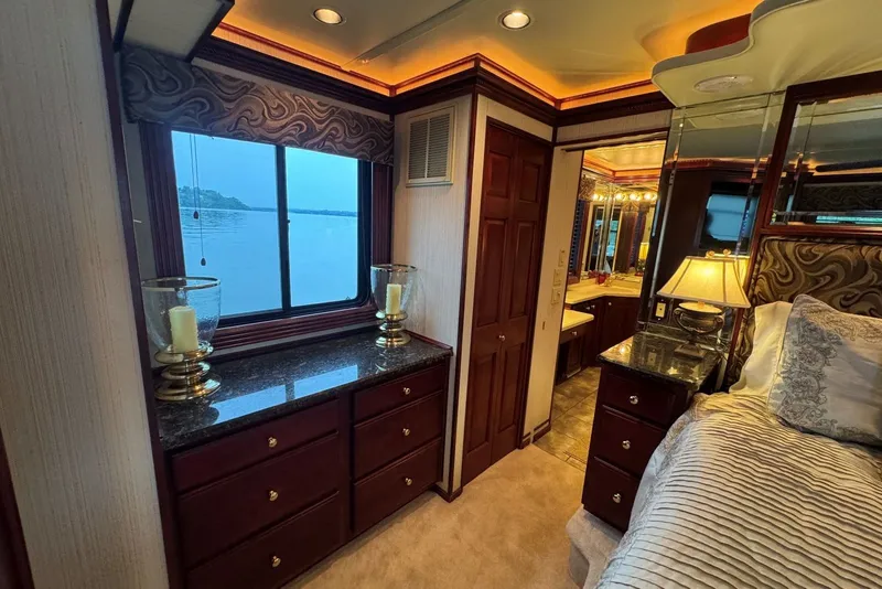 Slide: The Image of Luxurious 2005 Sumerset houseboat interior with elegant bedroom and lake view. - 83