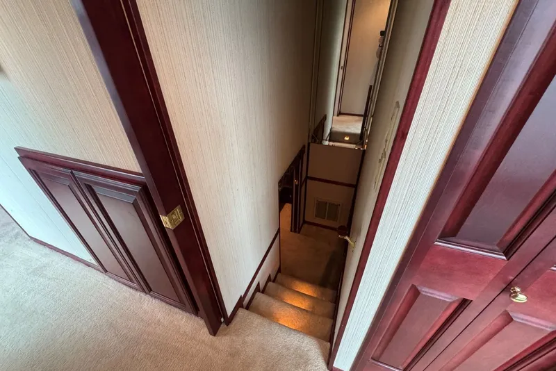 Slide: The Image of Staircase in 2005 Sumerset houseboat, featuring wooden paneling and carpeted steps. - 73