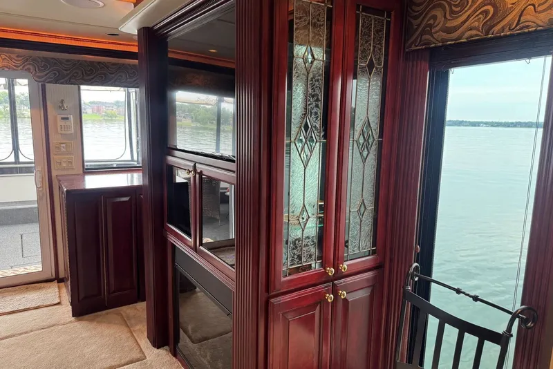 Slide: The Image of Luxurious 2005 Sumerset houseboat interior with elegant wood cabinetry and scenic water views. - 49