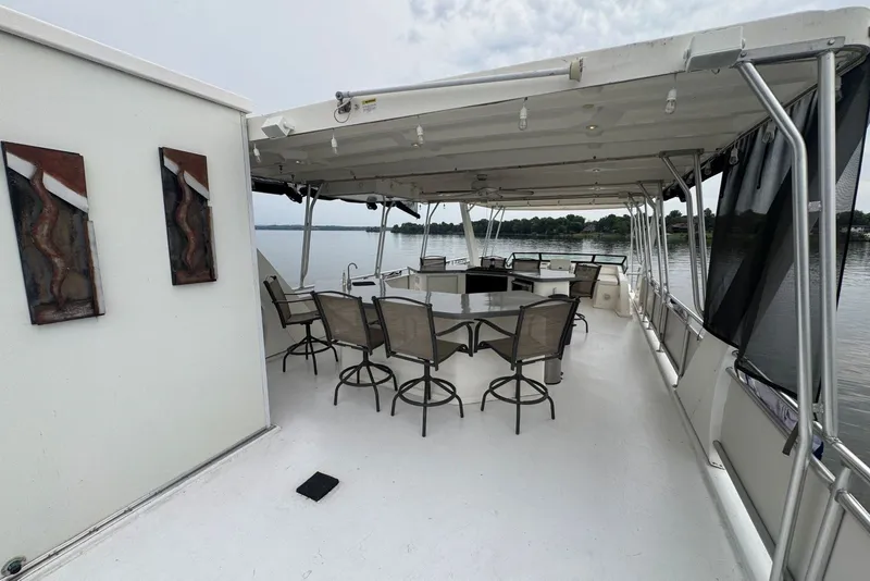 Slide: The Image of Upper deck of 2005 Sumerset houseboat with seating and lake view. - 36