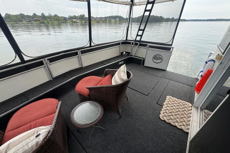 Slide: The Image of Houseboat interior with wicker chairs, red cushions, and lake view, Sumerset 16'6" X 63, 2005 model. - 21