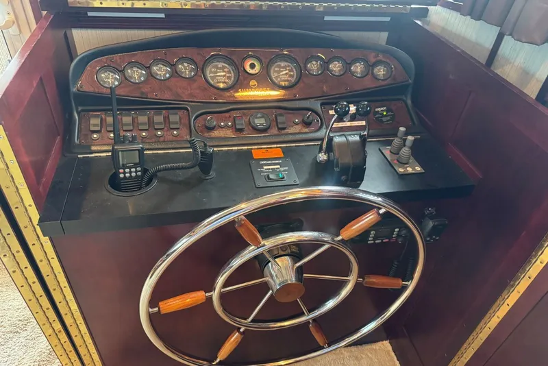 Slide: The Image of Control panel of a 2005 Sumerset 16'6" X 63 houseboat with steering wheel and gauges. - 40