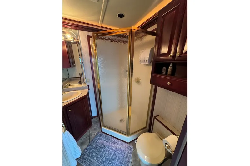 Slide: The Image of Luxurious bathroom in 2005 Sumerset houseboat with shower, sink, and wooden cabinetry. - 69