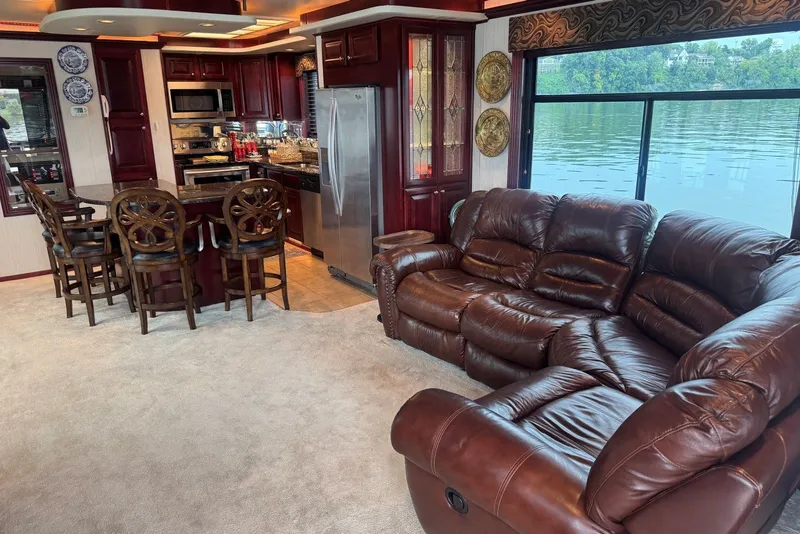 Slide: The Image of Luxurious 2005 Sumerset houseboat interior with leather seating, modern kitchen, and scenic water view. - 43