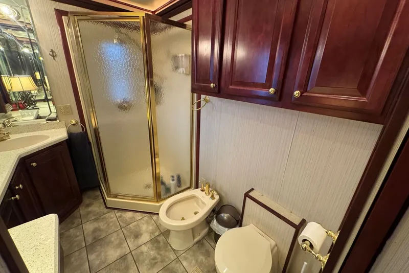 Slide: The Image of Luxurious bathroom in 2005 Sumerset houseboat with shower, toilet, and wooden cabinetry. - 87