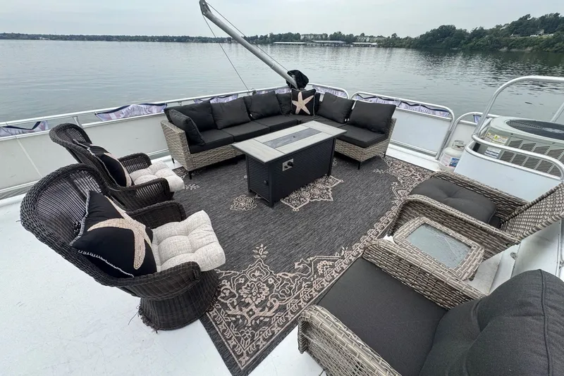 Slide: The Image of Luxurious 2005 Sumerset houseboat deck with elegant wicker furniture and scenic lake view. - 34