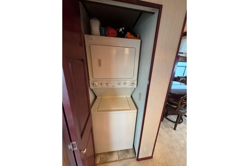 Slide: The Image of Stacked washer and dryer in a 2005 Sumerset 16'6" X 63 houseboat. - 64