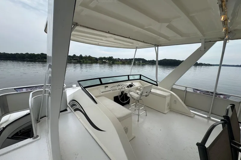 Slide: The Image of 2005 Sumerset 16'6" X 63 houseboat helm with lake view and seating area. - 23