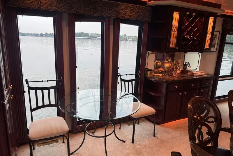 Slide: The Image of Luxurious 2005 Sumerset houseboat interior with elegant dining area and lake view. - 47