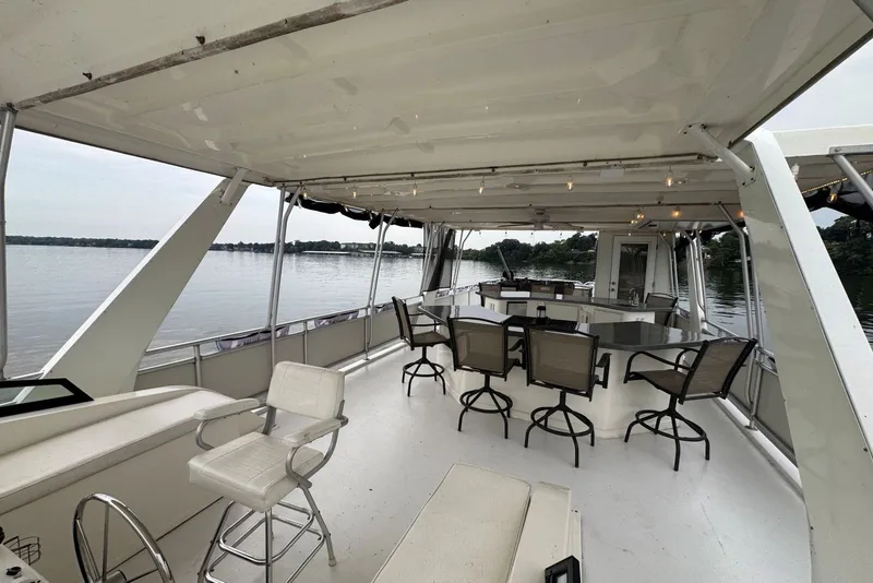Slide: The Image of Spacious deck of 2005 Sumerset houseboat with seating, overlooking serene water. - 26