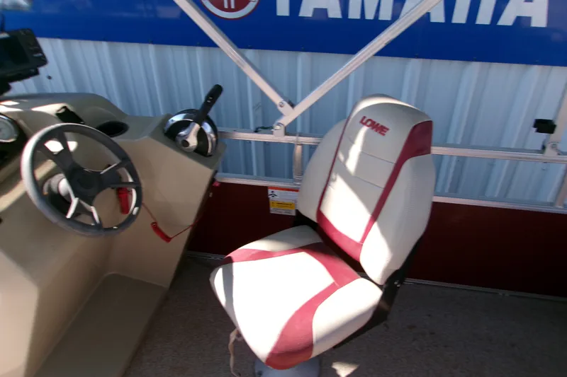 Slide: The Image of 2017 Lowe Ultra 162 Fish & Cruise boat interior with steering wheel and branded seat. - 13