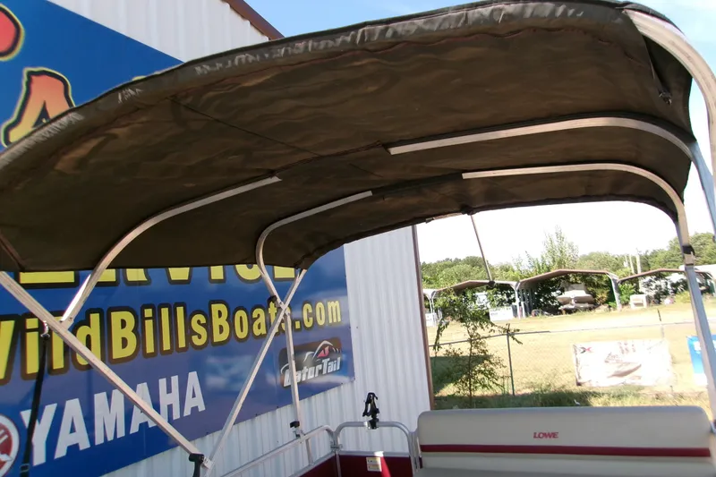 Slide: The Image of 2017 Lowe Ultra 162 Fish & Cruise boat with canopy, displayed at dealership. - 9