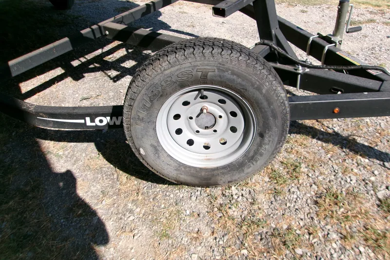Slide: The Image of Trailer wheel of a 2017 Lowe Ultra 162 Fish & Cruise boat on gravel. - 17