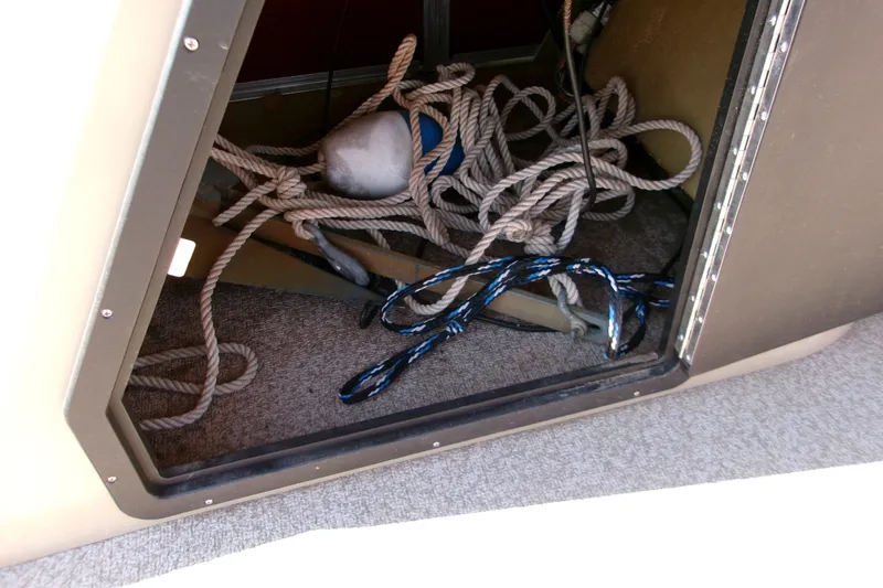 Slide: The Image of Storage compartment with ropes and anchor on a 2017 Lowe Ultra 162 Fish & Cruise boat. - 16