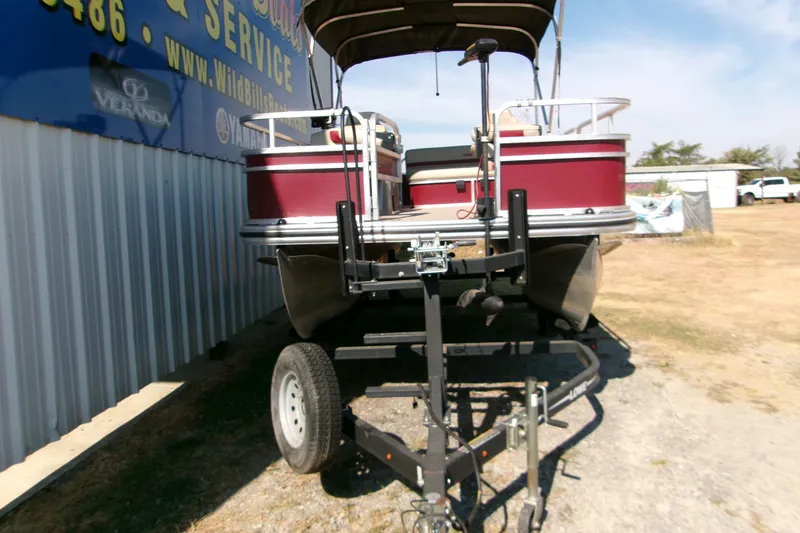 Slide: The Image of 2017 Lowe Ultra 162 Fish & Cruise pontoon boat on trailer, parked outdoors. - 10