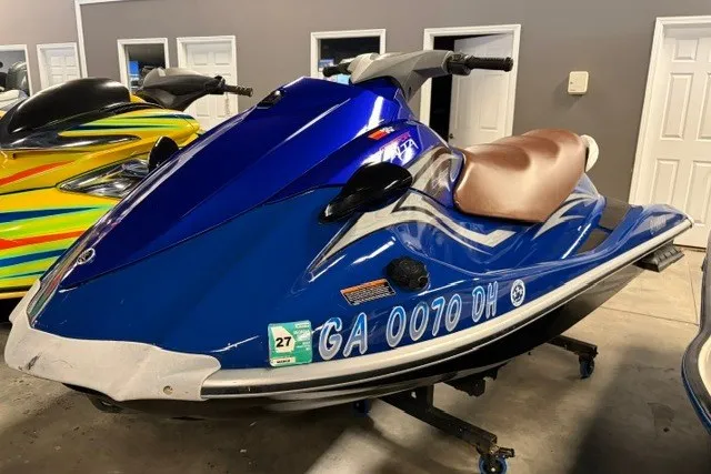 The Image of 2008 Yamaha VX Cruiser in blue, parked indoors, showcasing sleek design and registration details. - 0