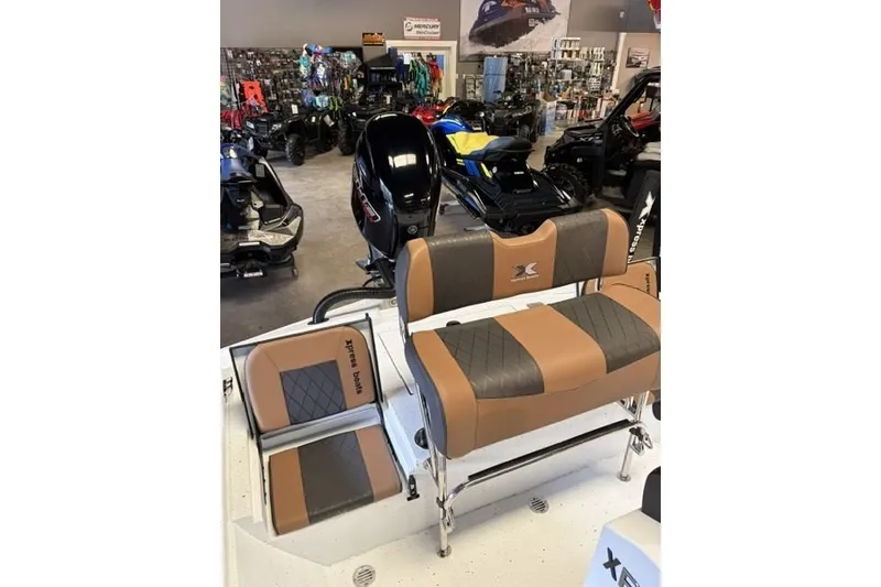 Slide: The Image of 2027 Xpress XR21 Bay boat interior with tan and gray seating in showroom. - 17