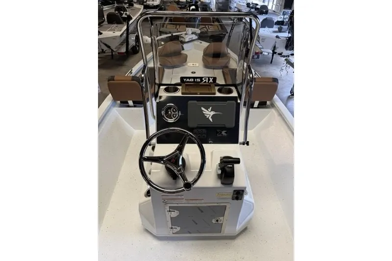 Slide: The Image of 2027 Xpress XR21 Bay boat interior with steering wheel and dashboard controls. - 15