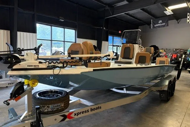 The Image of 2027 Xpress XR21 Bay boat in showroom, featuring Minn Kota trolling motor. - 1