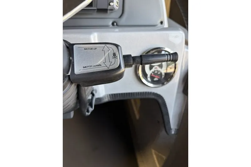 Slide: The Image of Close-up of 2027 Xpress H20 Crappie boat control panel with motor adjustment switch. - 15