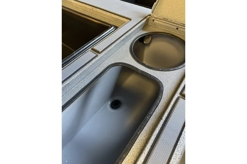 Slide: The Image of Interior view of 2027 Xpress H20 Crappie boat's storage compartments and cup holder. - 10