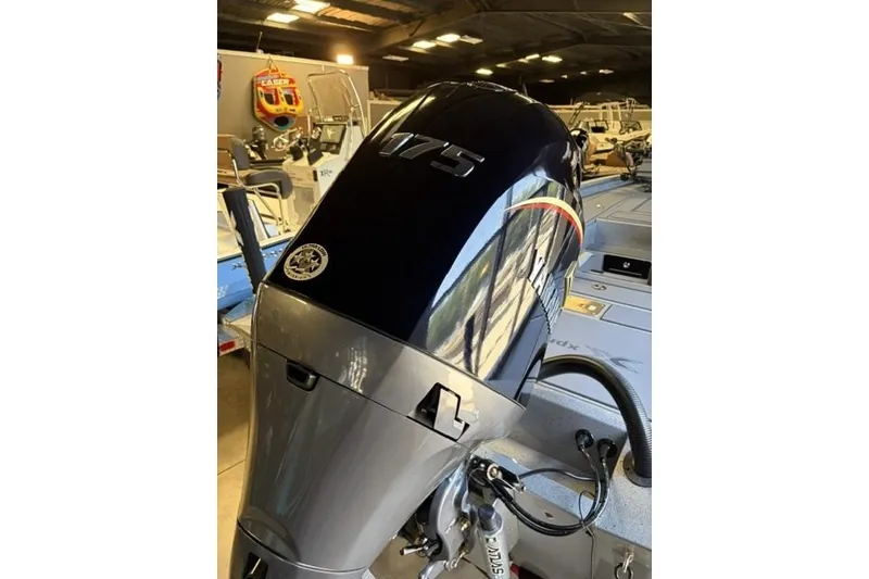 Slide: The Image of Outboard motor on 2027 Xpress H20 Crappie boat in showroom setting. - 4