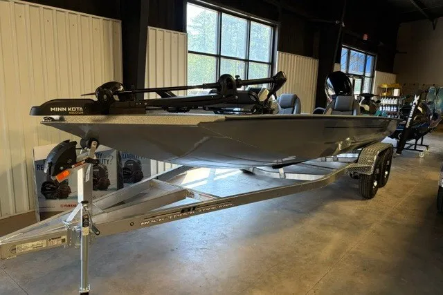 The Image of 2027 Xpress H20 Crappie boat with trailer in indoor showroom. - 1