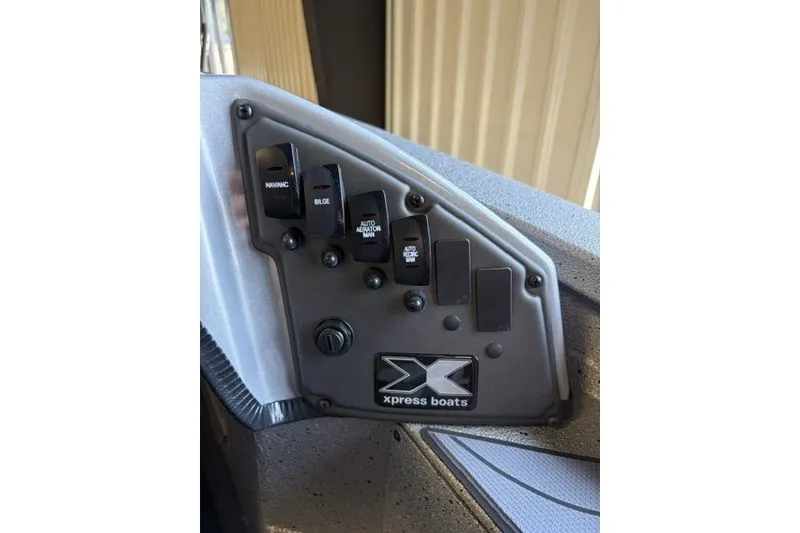 Slide: The Image of Control panel of 2027 Xpress H20 Crappie boat with labeled switches. - 16