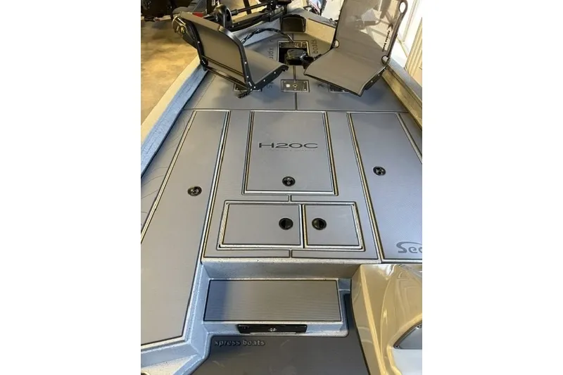 Slide: The Image of 2027 Xpress H20 Crappie boat interior with seating and storage compartments. - 7