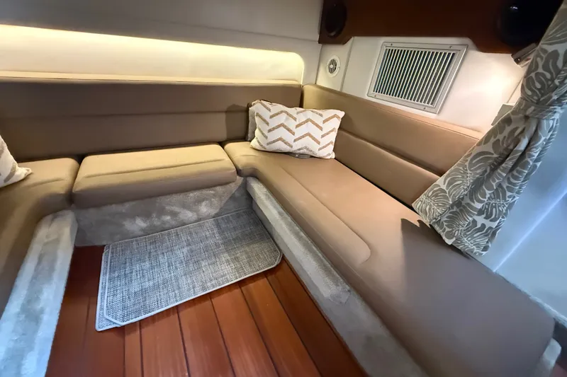 Slide: The Image of Interior of 2019 Crownline 350 SY yacht with beige seating and decorative pillows. - 25