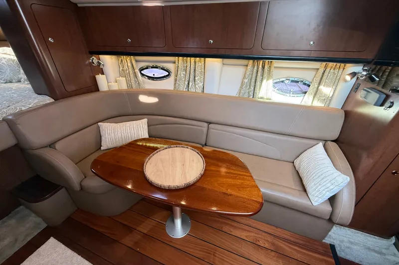 Slide: The Image of Luxurious interior of 2019 Crownline 350 SY yacht with elegant seating and wooden table. - 20