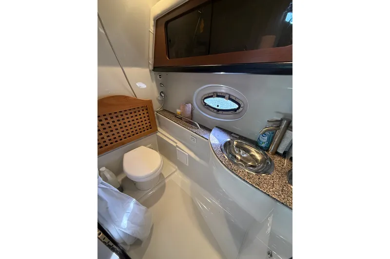 Slide: The Image of Luxurious bathroom in 2019 Crownline 350 SY yacht with modern fixtures and porthole window. - 23