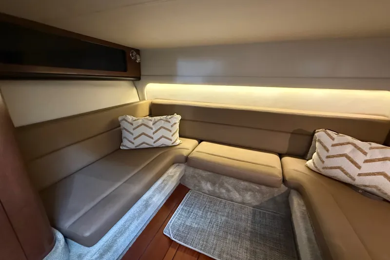 Slide: The Image of Interior of 2019 Crownline 350 SY yacht with beige seating and decorative pillows. - 26