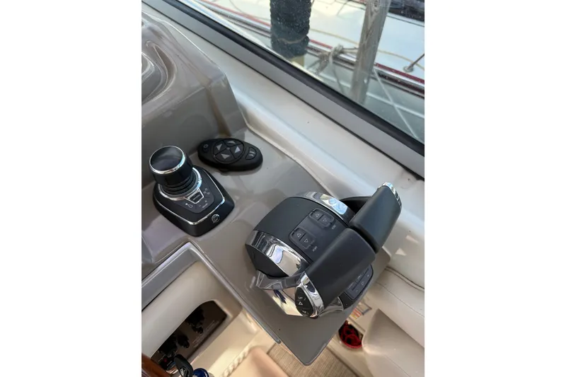 Slide: The Image of Control panel of a 2019 Crownline 350 SY boat, featuring joystick and throttle controls. - 17