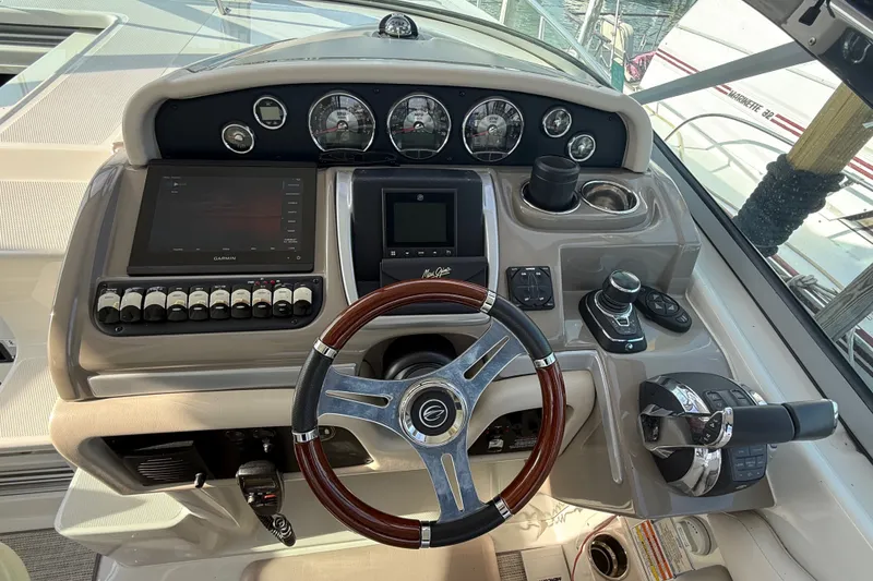 Slide: The Image of Cockpit of 2019 Crownline 350 SY boat with steering wheel and navigation controls. - 16